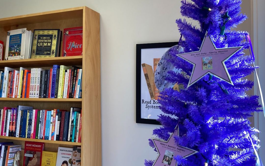 A purple Christmas tree with star ornaments